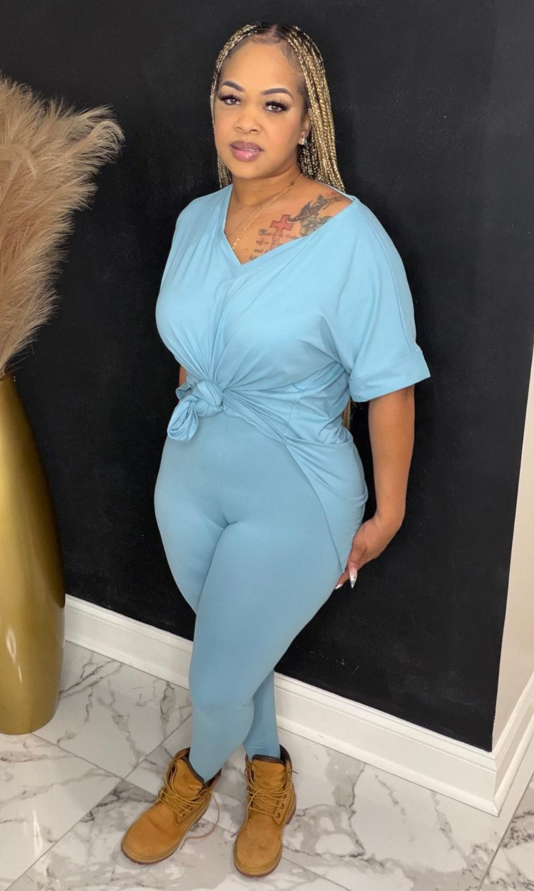 Side angle of Basic Set Dusty Teal two-piece set showing high-waisted leggings and knotted top detail.
