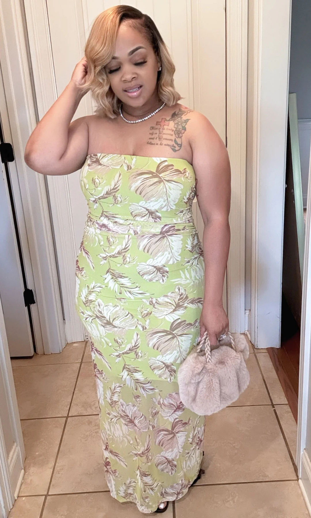 Woman wearing a floral dress holding a handbag indoors. Classic Classy Summer Dress