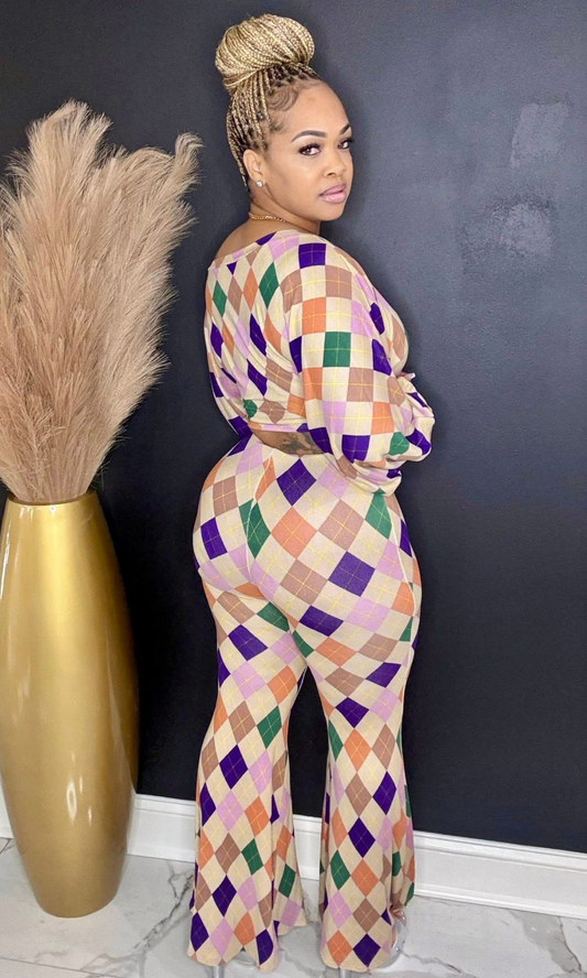 Model wearing Color Story Flare Set in size medium, featuring long-sleeve top and high-waisted flare pants in multi-color diamond print. Back view.