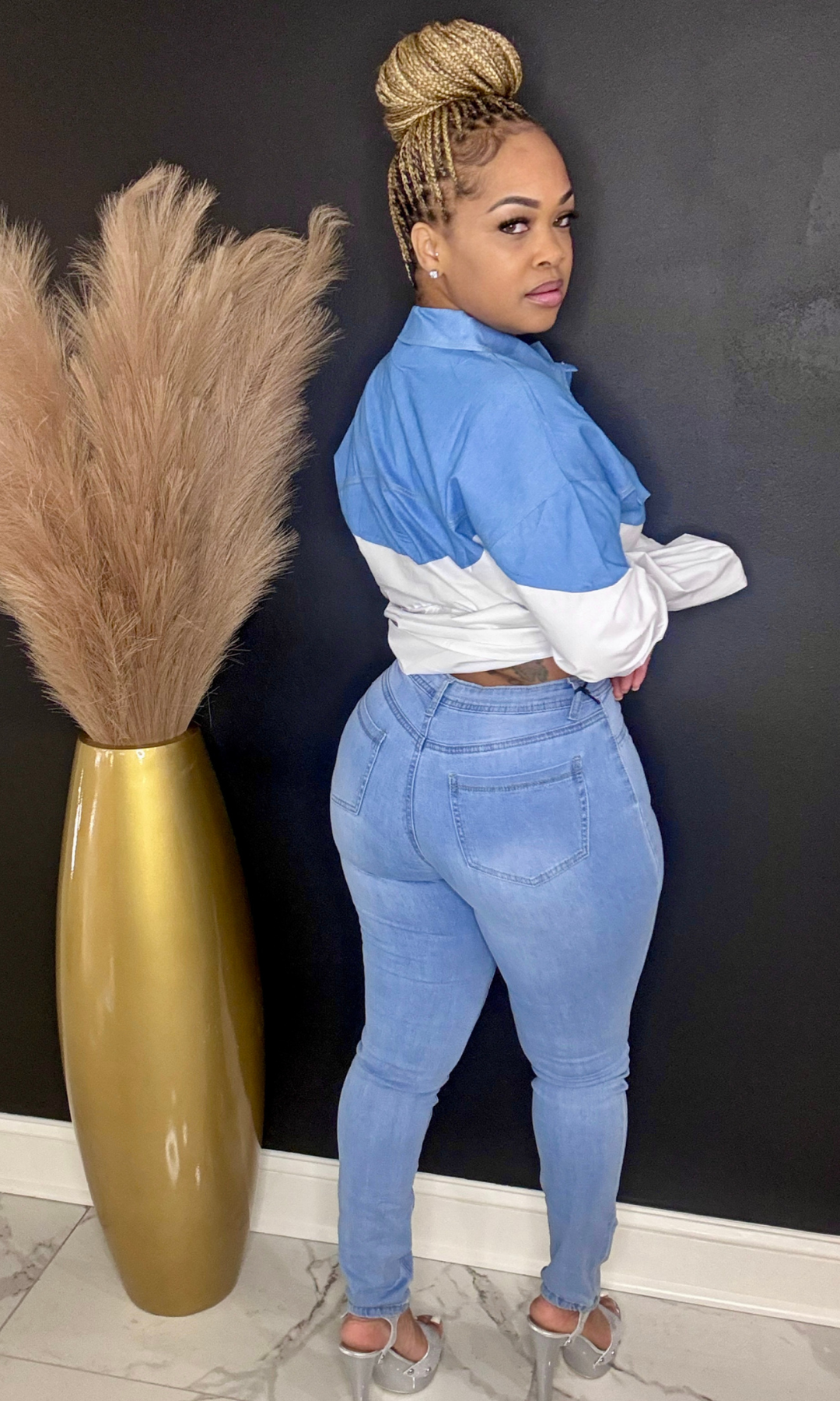 Model wearing Denim Blue stretch skinny jeans, back view showing light-wash detail.