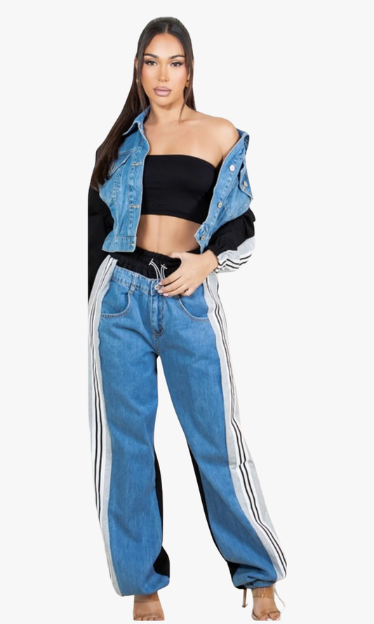 Woman wearing a black crop top, blue denim jacket, and blue jeans with white stripes on a white background
