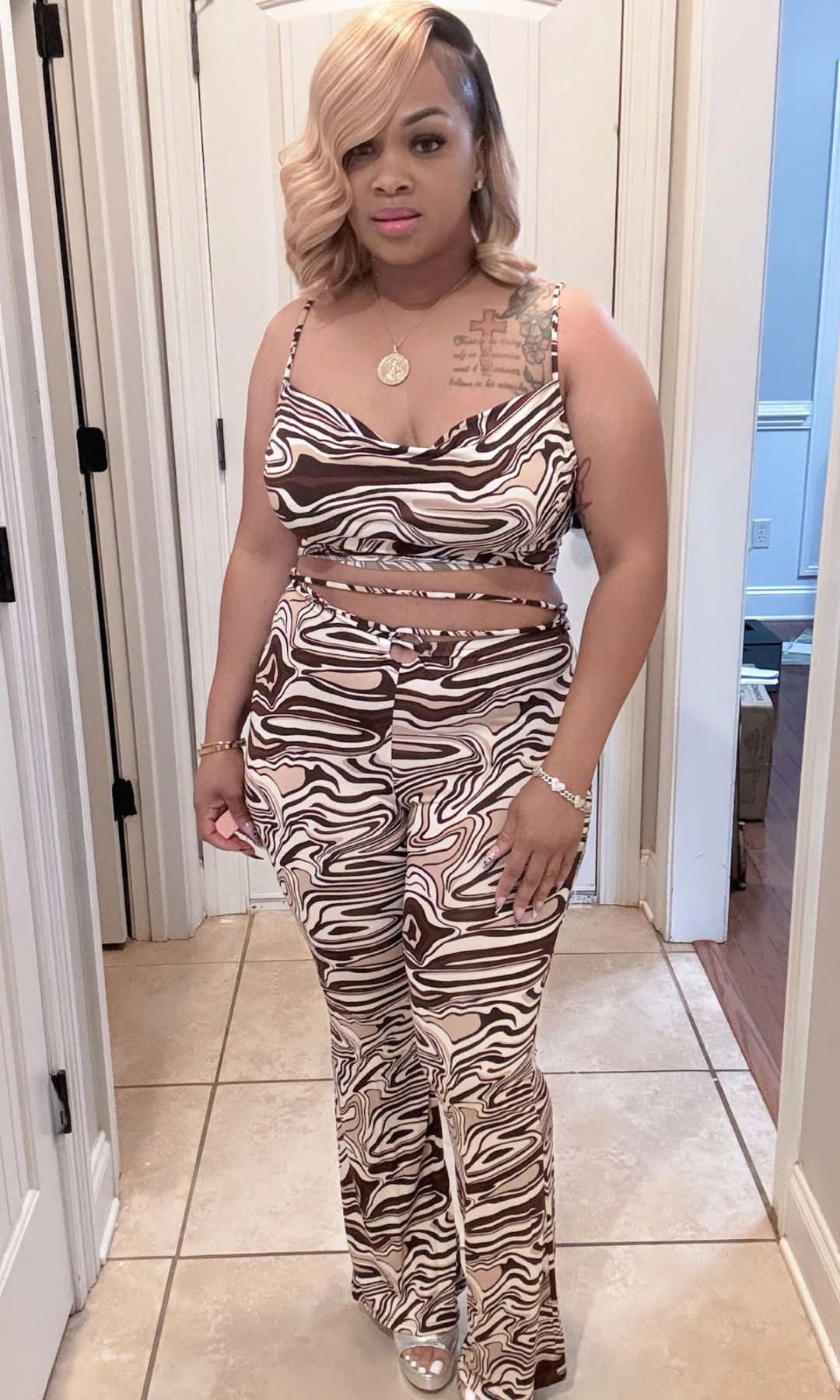 Front view of Envy Chic Couture’s Kingdom Set featuring a cowl neck cami with wrap tie and matching flare pants in bold brown and cream swirl print.