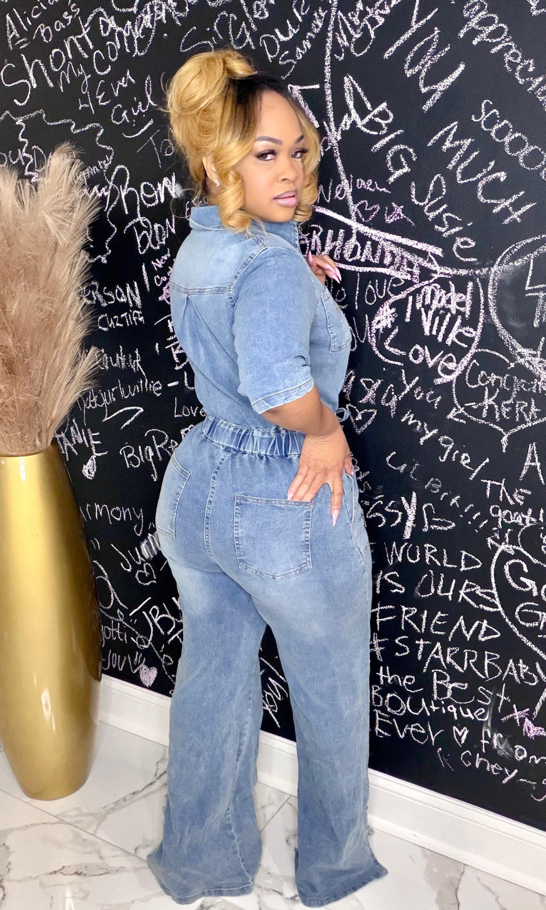 Lex Jean Romper back view – Denim romper with functional back pockets and wide-leg design