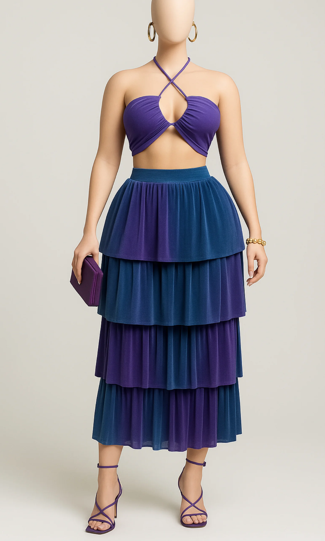 Mannequin wearing a purple and blue tiered dress on a plain background