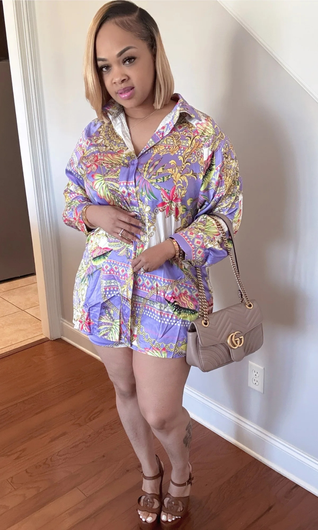 Side-front view of woman wearing the Spring Time 2-piece set in colorful floral and chain print with untied shirt.