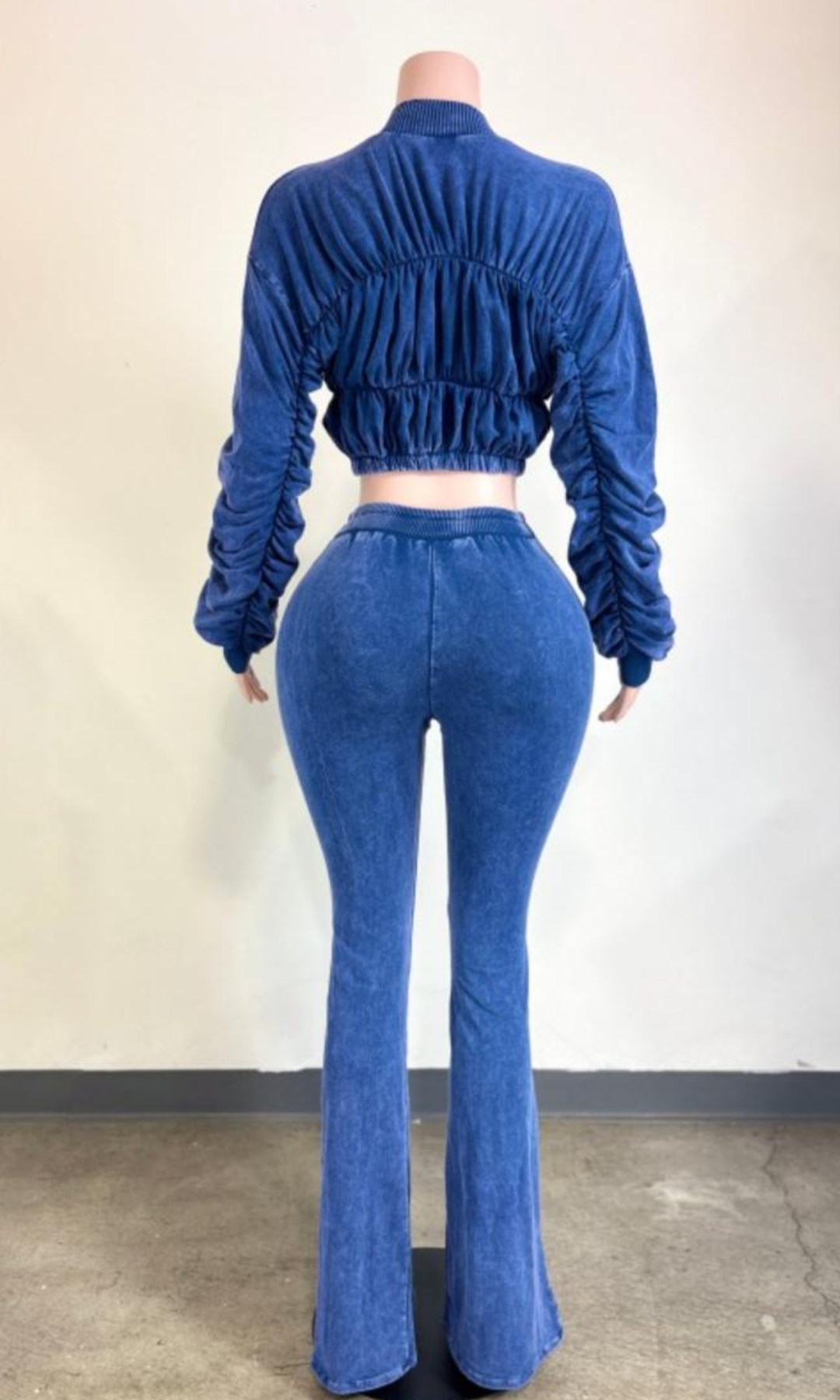 Back view of The Weekend Ruched Set Blue showing the ruched cropped jacket with elasticized hem, gathered sleeves, and coordinating high-waisted flared pants.