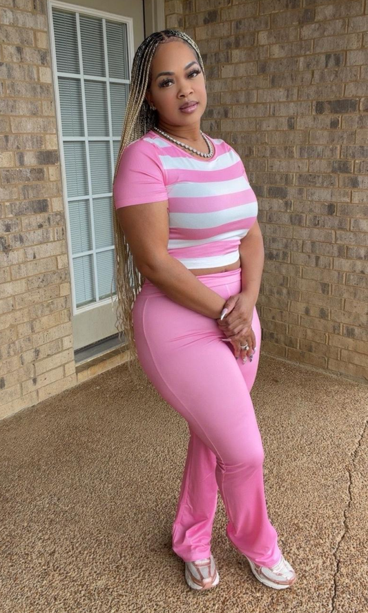 Woman modeling the Cotton Candy 2pc Set featuring a fitted pink-and-white striped short-sleeve top and coordinating high-waisted solid pink full-length pants.
