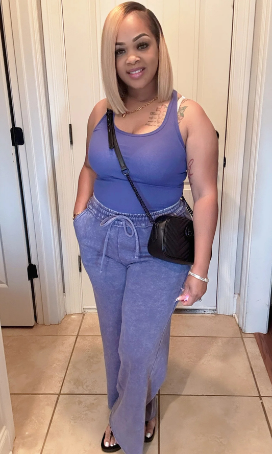 Front pose of model in washed blue tank and pants set with hands in pockets.