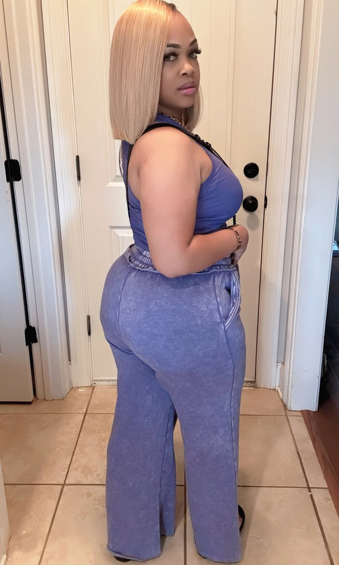 Rear view of model in washed blue tank and pants set, showing relaxed fit.