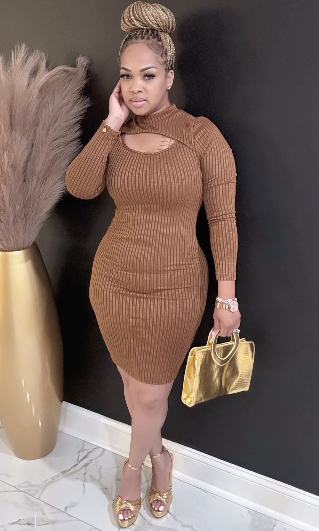 Front view of model wearing brown ribbed Autumn Fall dress with cutout detail.