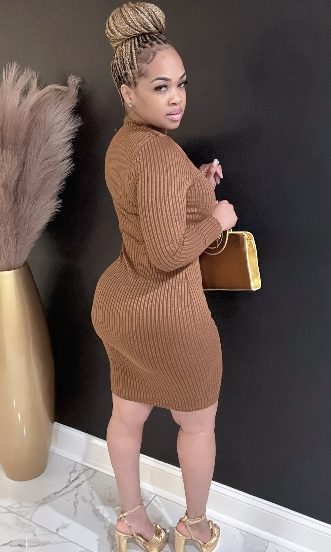 Back view of model wearing brown ribbed Autumn Fall dress with cutout detail.