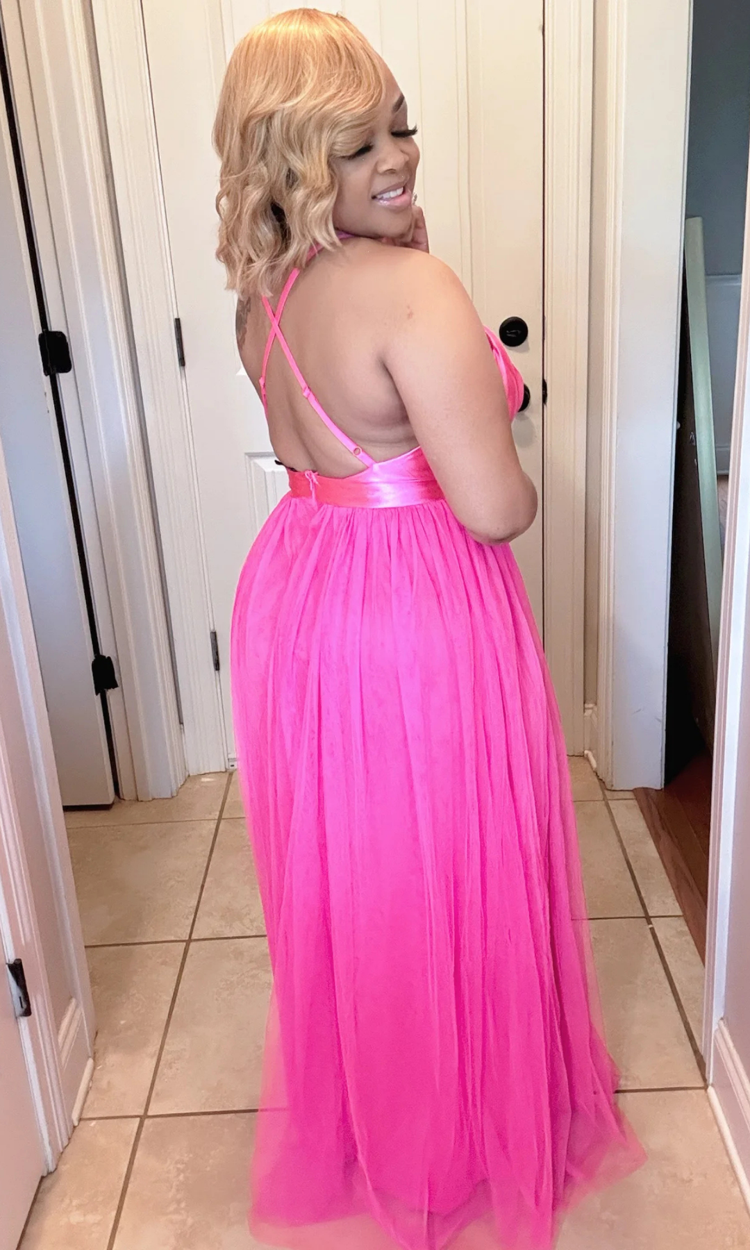 Back view of Barbie Pink Maxi Dress showing crisscross straps and flowing maxi skirt in hot pink.