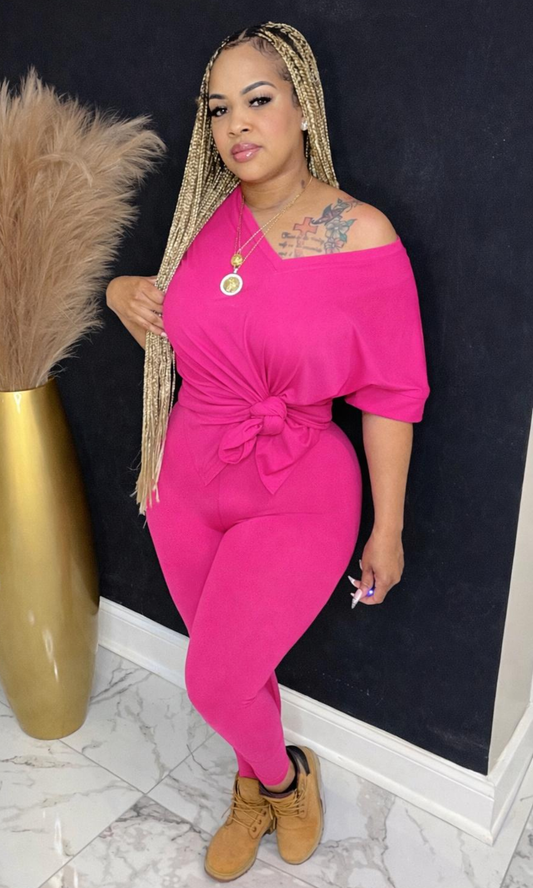 Model wearing Basic Set Hot Pink in size medium, front view styled with boots, featuring high-waisted leggings and knotted top detail.