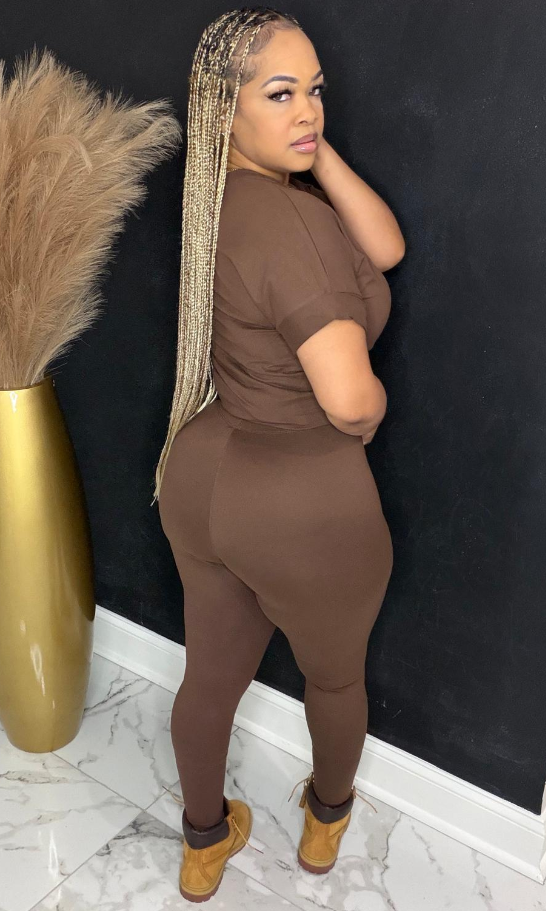 Side angle view of Basic Set Brown two-piece set styled with boots.