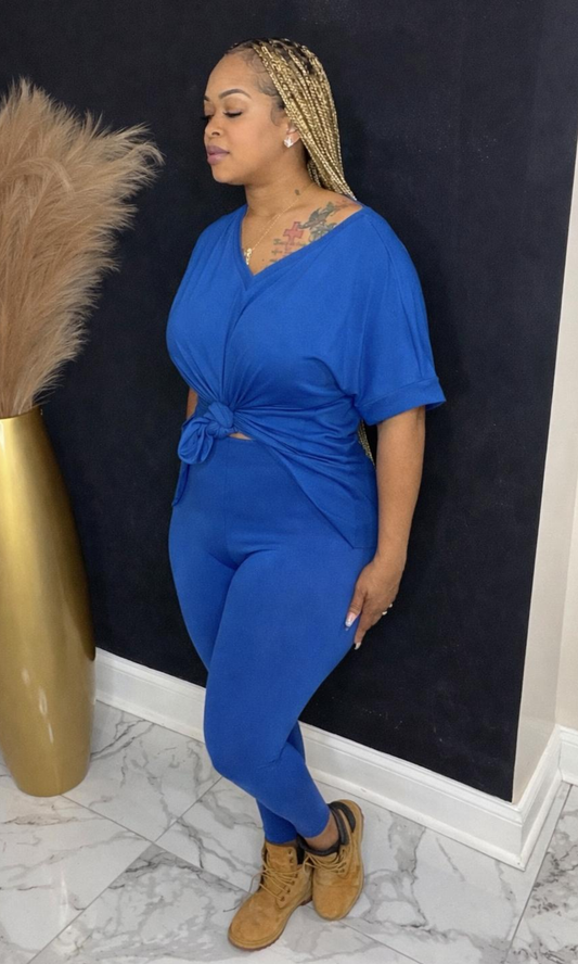 Model wearing Basic Set Classic Blue in size medium, side view styled with boots, featuring high-waisted leggings and knotted top detail.