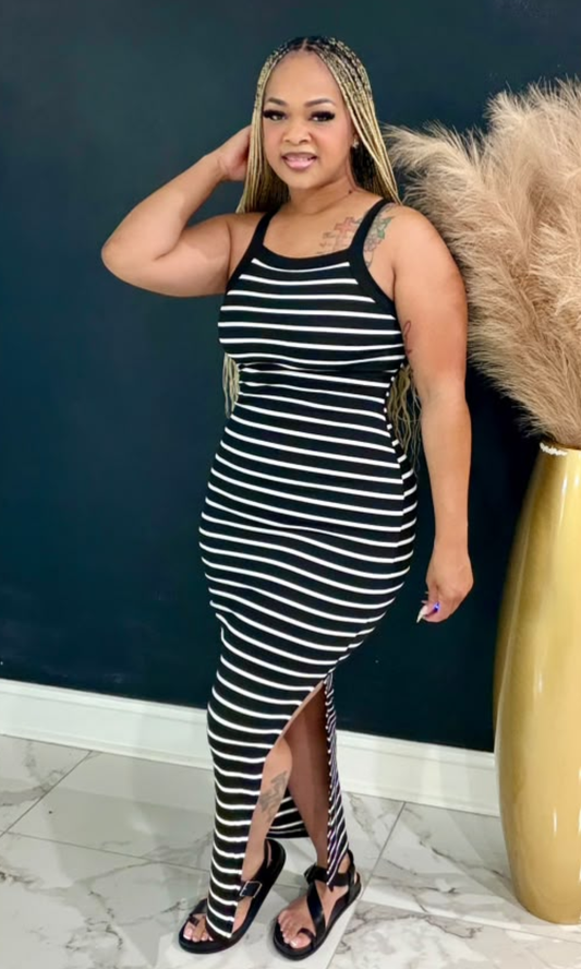 Model wearing the Basic Striped Maxi Dress featuring black and white stripes, a sleeveless design, and a flattering bodycon silhouette.