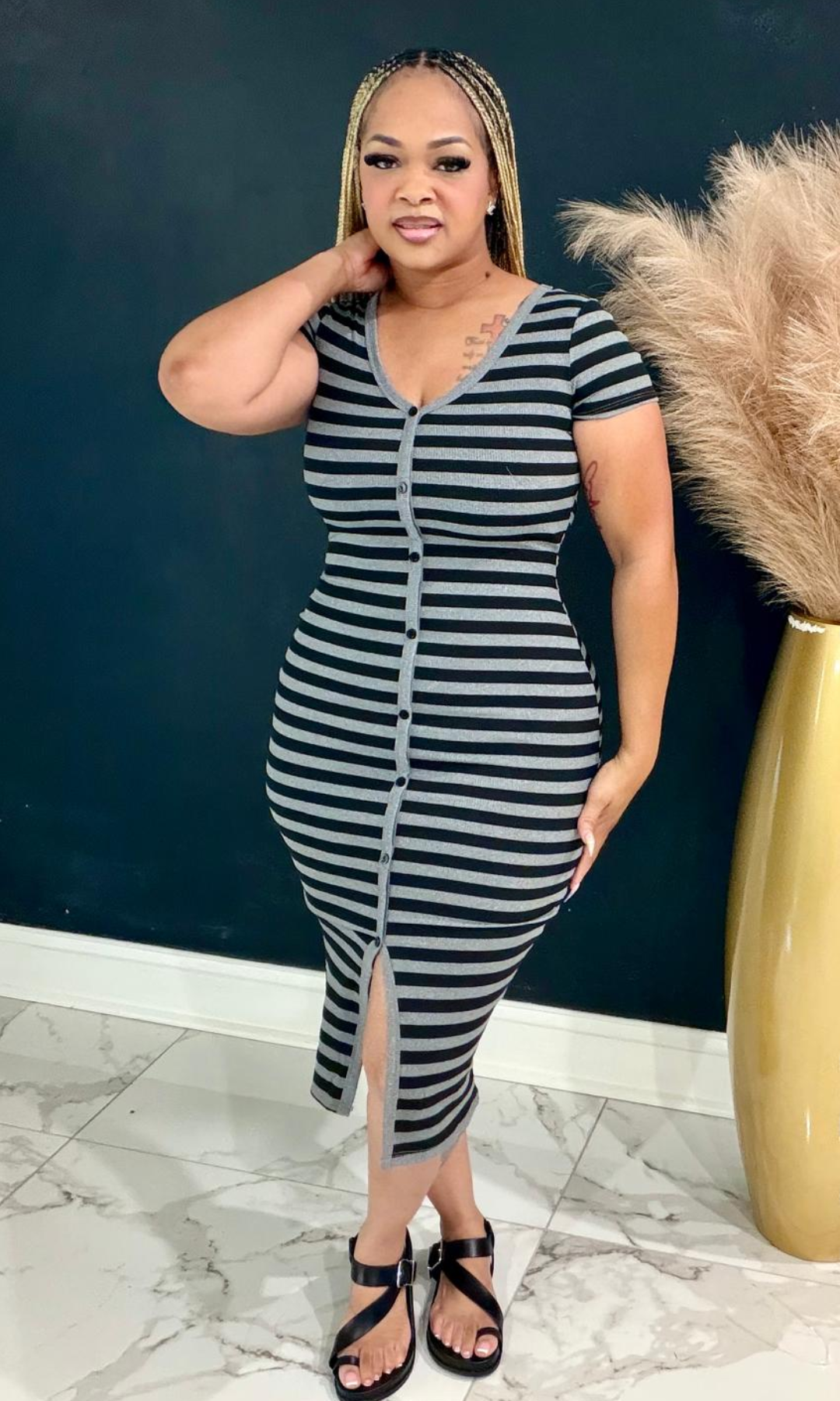 Model wearing the Black Basic Striped Maxi Dress featuring a button-front design, front slit, and flattering bodycon silhouette.