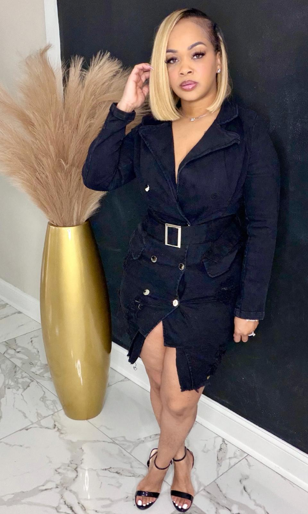 Black denim jean belt dress with silver buckle belt, long sleeves, distressed hem, and double-breasted buttons – front view.