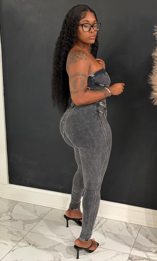 Woman wearing the Black Sexy Diana strapless jumpsuit with ribbed fabric and contrast seam detailing.