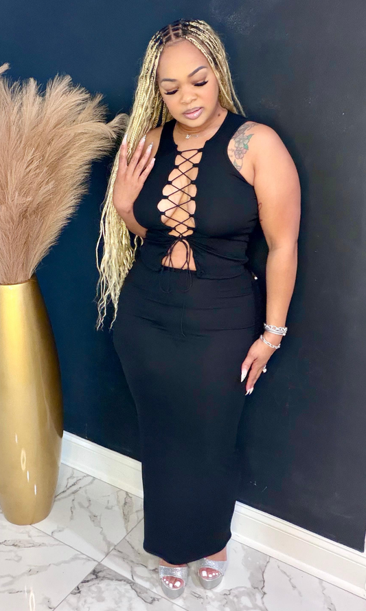 Black tie two piece skirt set angled view highlighting lace-up neckline and body-hugging fit