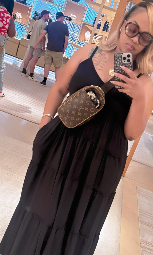 Woman holding a Louis Vuitton belt bag in a store setting