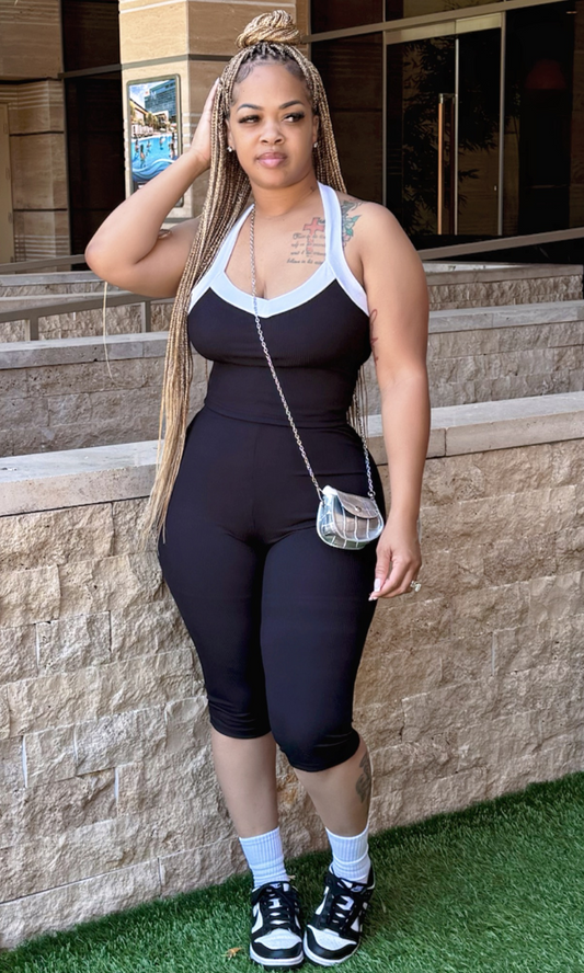 Black & White 2-piece set front view – Model in size medium showcasing sleeveless black outfit with white trim and cropped pants.