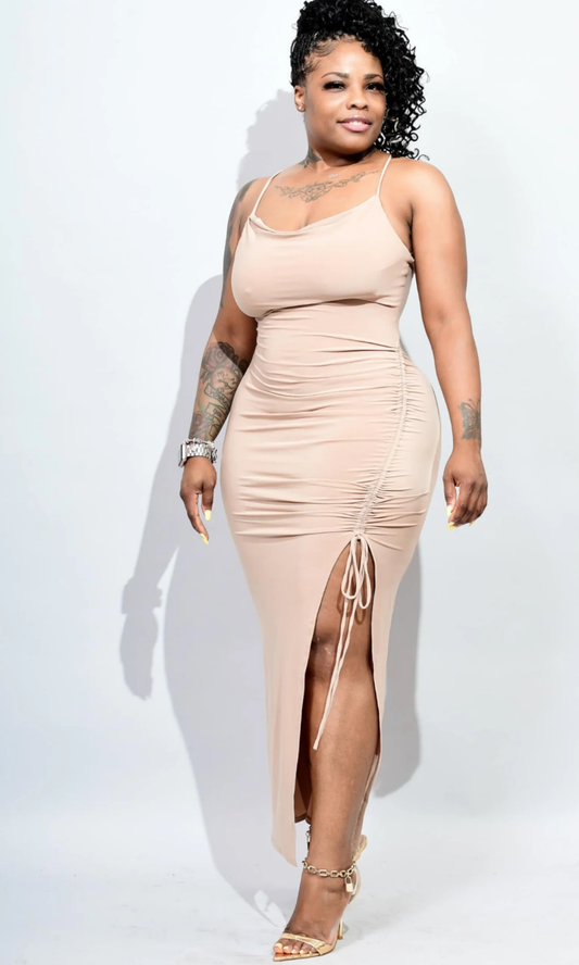 Woman wearing fitted sleeveless maxi dress with deep V-neckline and sleek silhouette, posed facing forward.