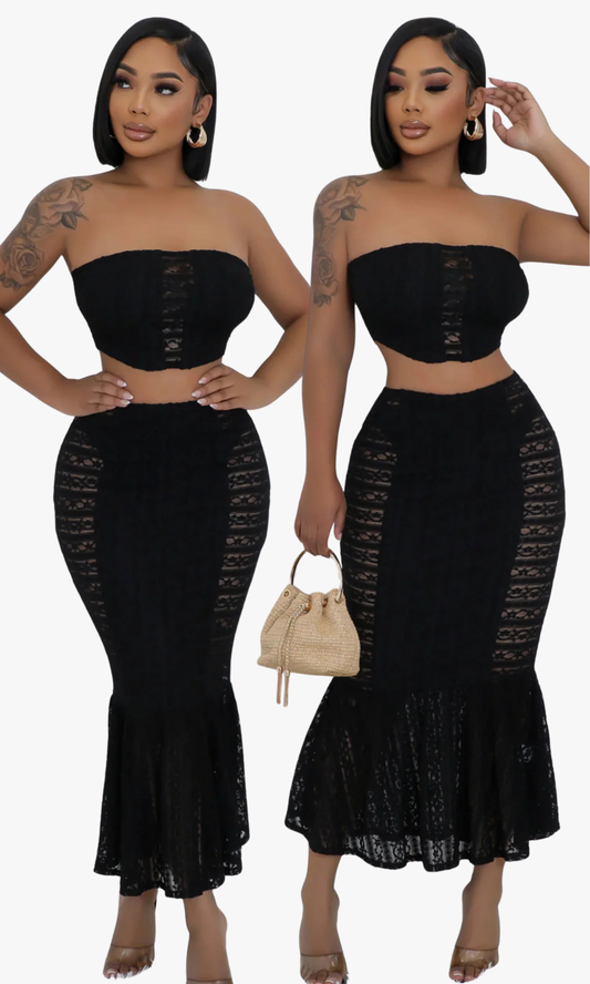 Woman wearing a Butterfly black strapless top and skirt set with lace details.
