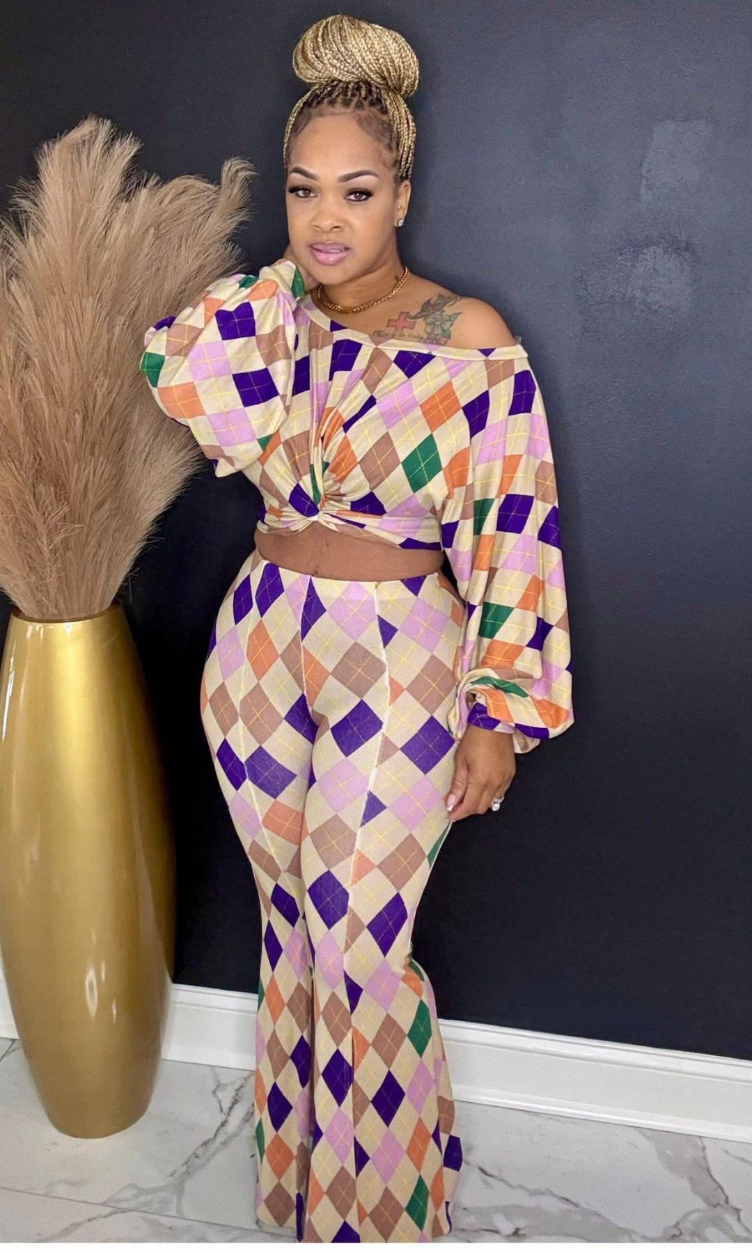 Model wearing Color Story Flare Set in size medium, featuring long-sleeve top and high-waisted flare pants in multi-color diamond print.