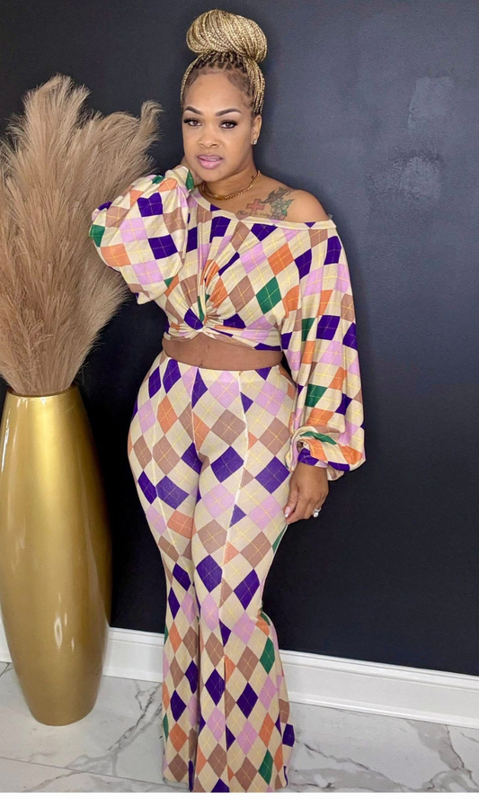 Model wearing Color Story Flare Set in size medium, featuring long-sleeve top and high-waisted flare pants in multi-color diamond print.