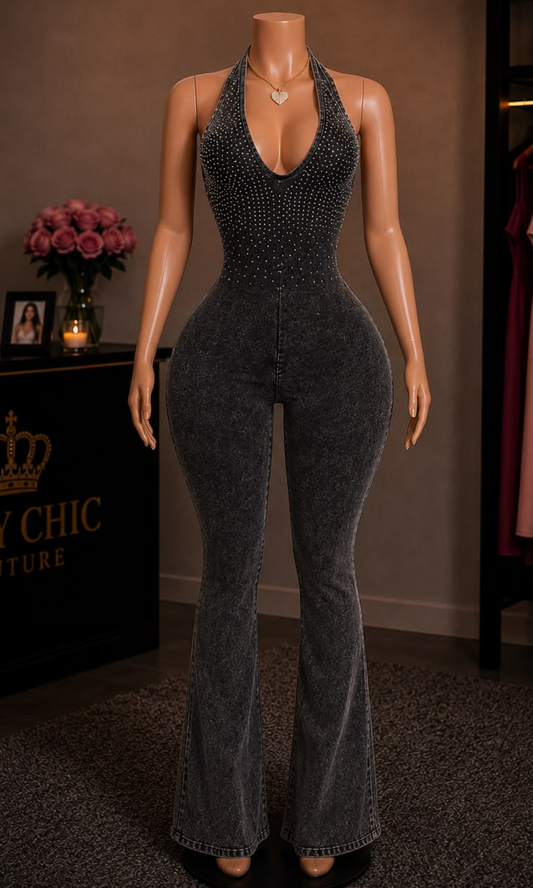 Women's washed black halter jumpsuit featuring rhinestone embellishments, a plunging neckline, open back, and flared legs.