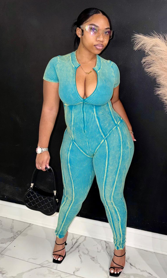 Green Dream ribbed jumpsuit featuring a mineral-wash finish, zip-front neckline, contrast seam detailing, and a flattering bodycon silhouette for a bold, modern look.