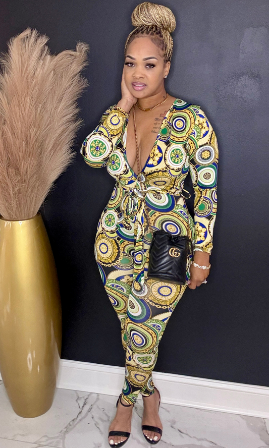 Woman wearing Green & Gold Lux jumpsuit front view with deep V neckline