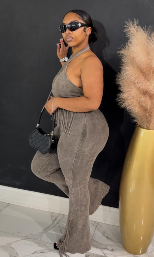 Woman wearing the Grey Fringe two-piece set featuring a halter fringe crop top and high-waisted flare pants.