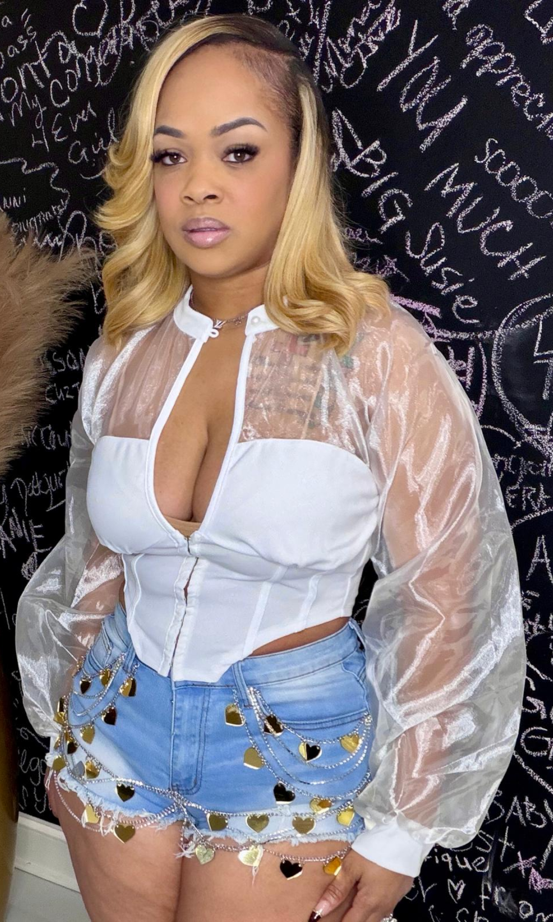 Side view of Heart Desire Shorts styled with a sheer long sleeve top