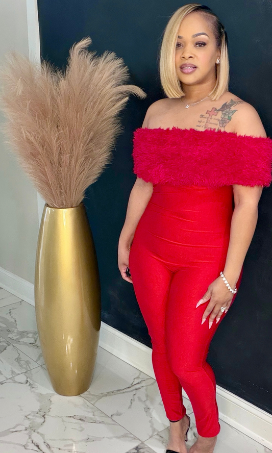 Model wearing Power Play Jumpsuit front view highlighting off-shoulder neckline