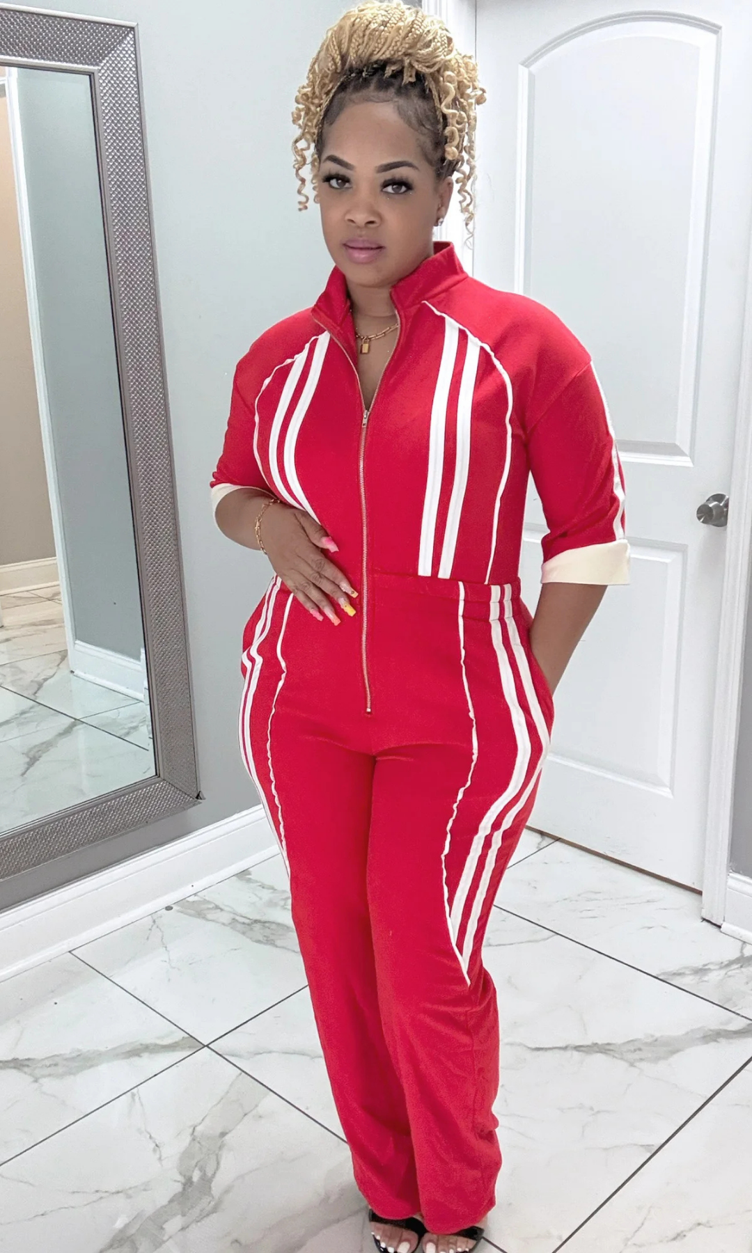 Front view of It’s Bad Red jumpsuit with white stripe accents.