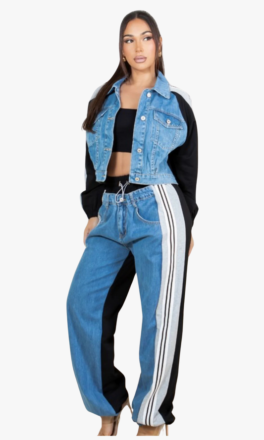 Woman wearing a black and blue outfit with a denim jacket and track pants on a white background
