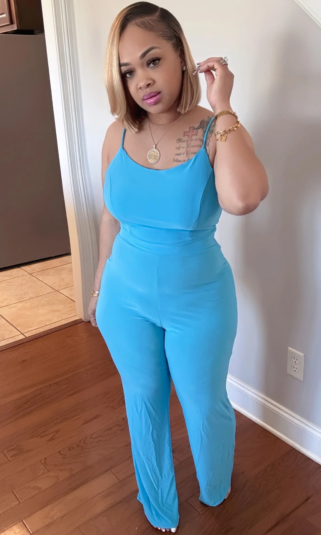 Full front view of blue jumpsuit with sleek silhouette and straight-leg cut.