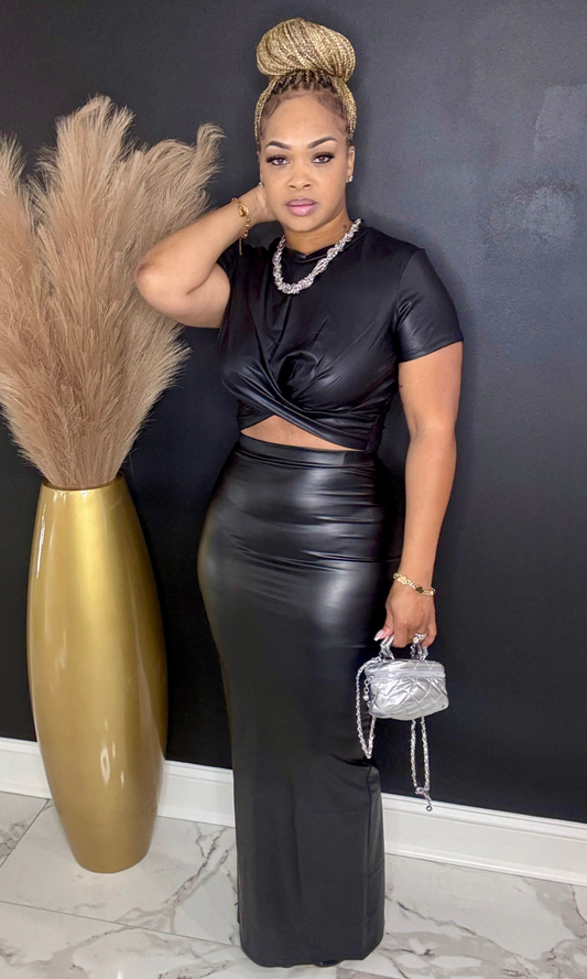 Woman wearing Leather Black two-piece faux leather skirt set, front view.