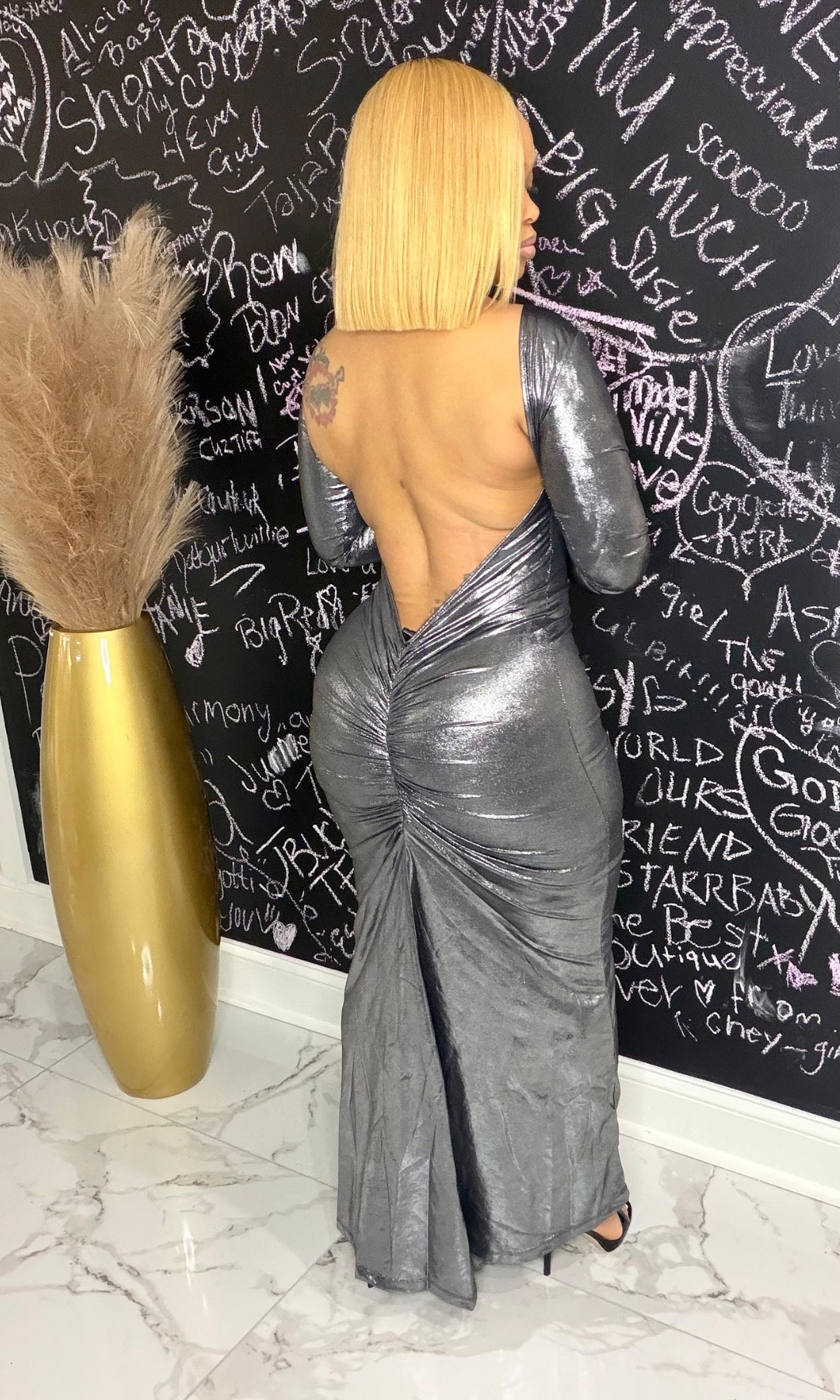 Back view of Magic Made Dress showing open back and fitted metallic fabric
