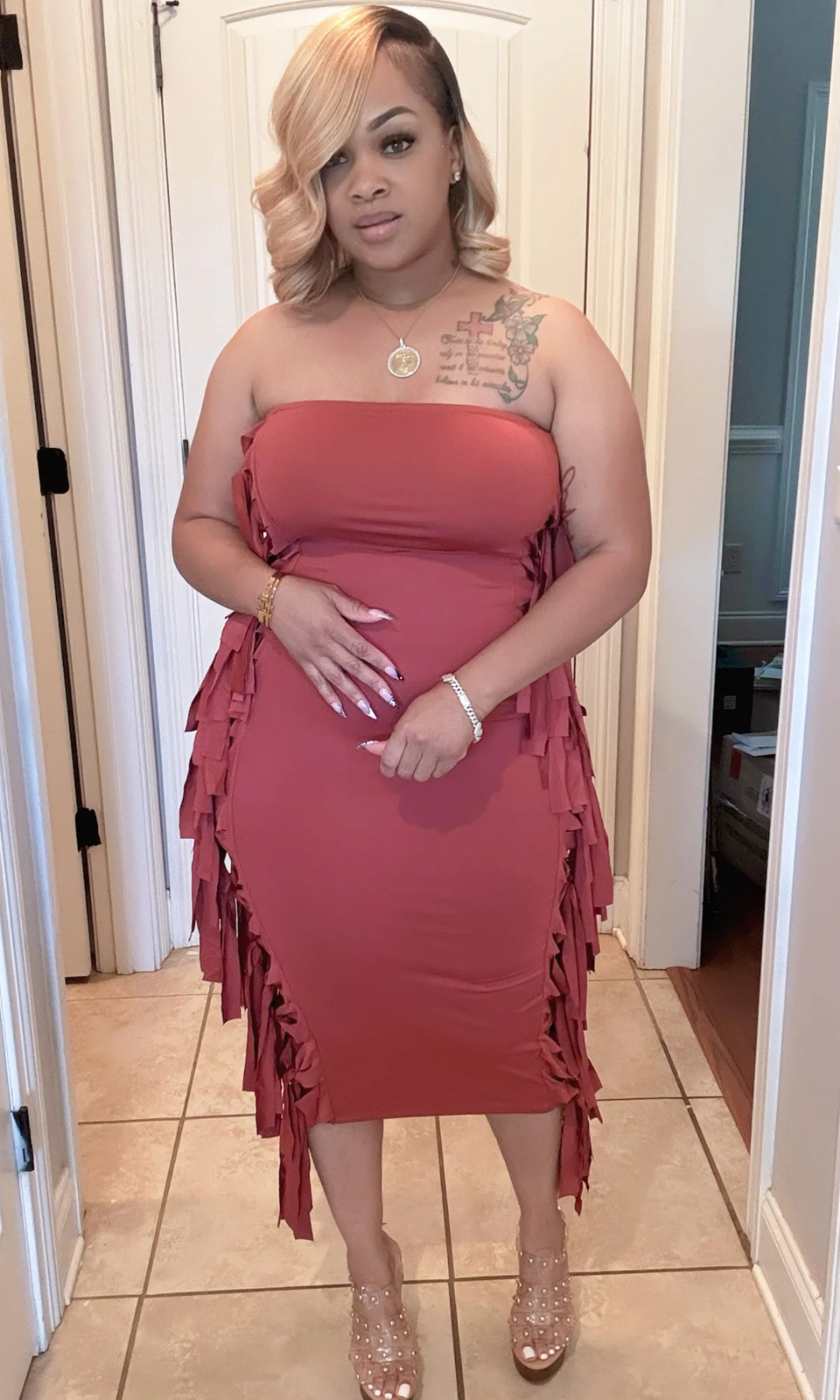 Woman wearing rust-colored strapless fringe midi dress, front view