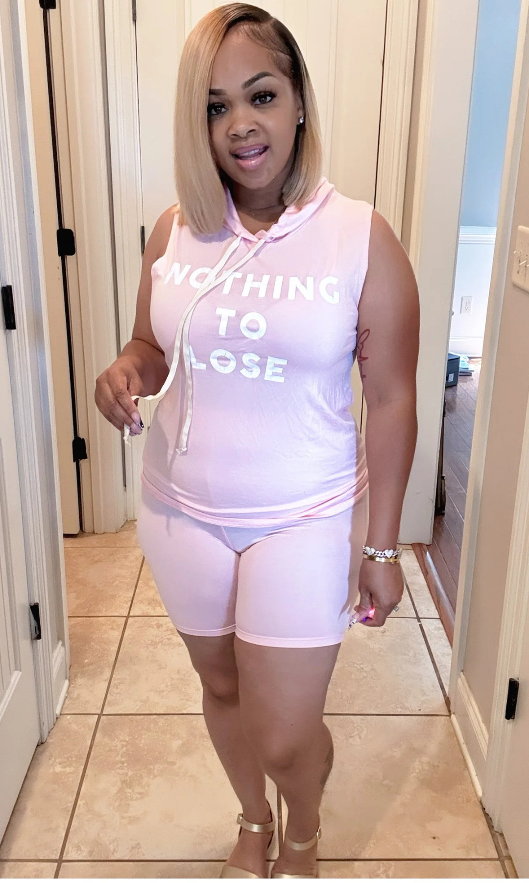 Casual two-piece biker shorts set in pink with bold printed statement.
