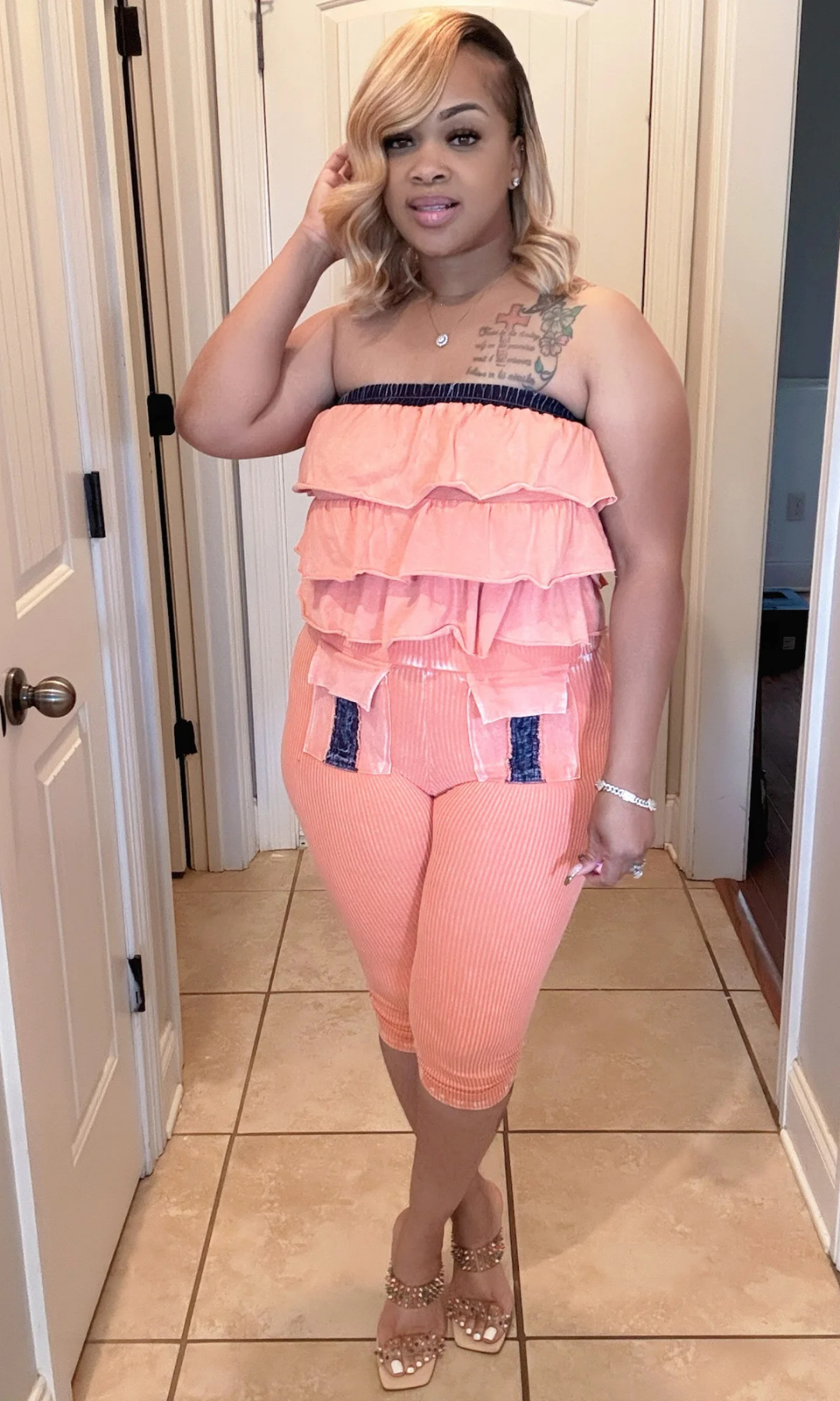 Front view of Orange Mania outfit showing ruffle details and denim pocket accents.