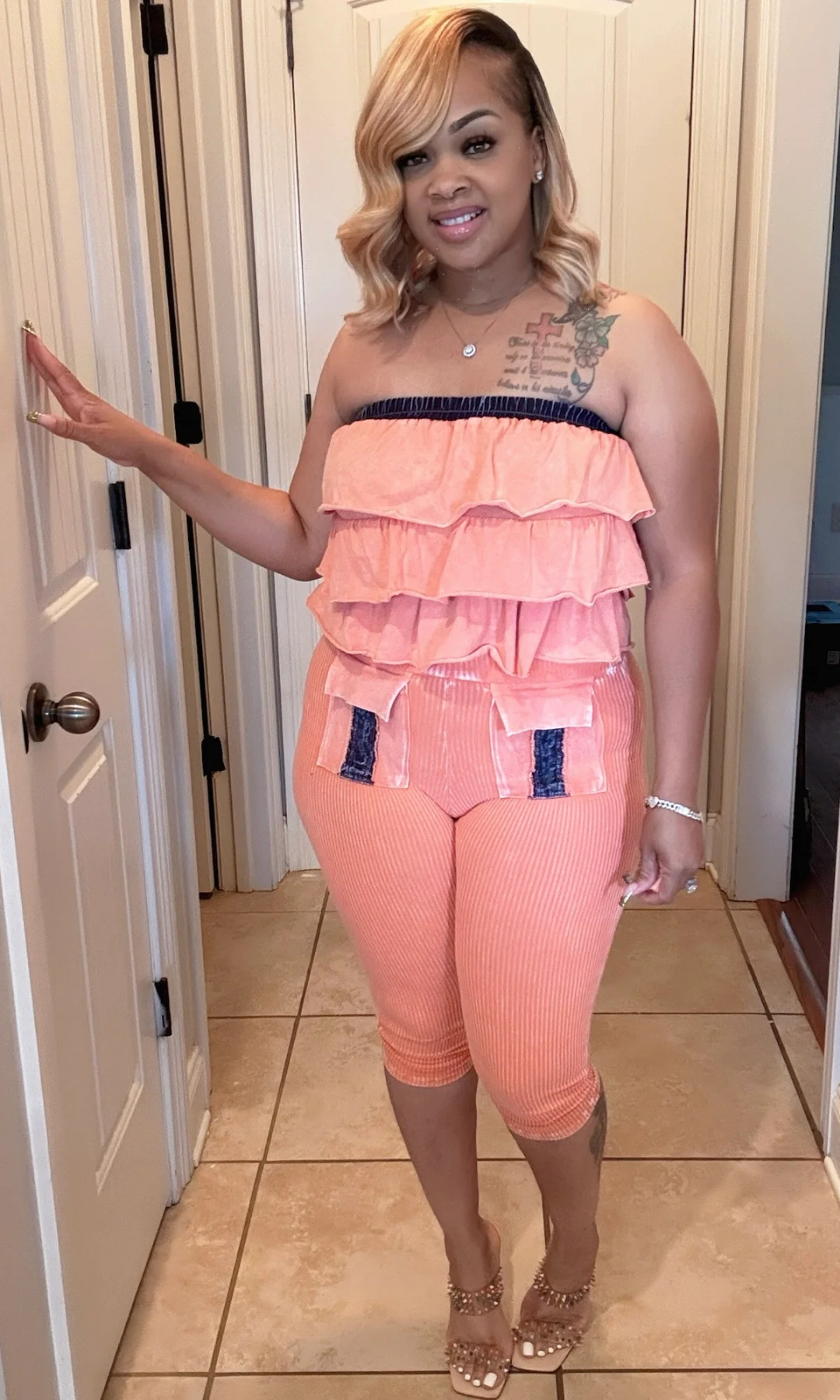 Model posing in Orange Mania ribbed fabric two-piece set, perfect for casual or dressy looks.