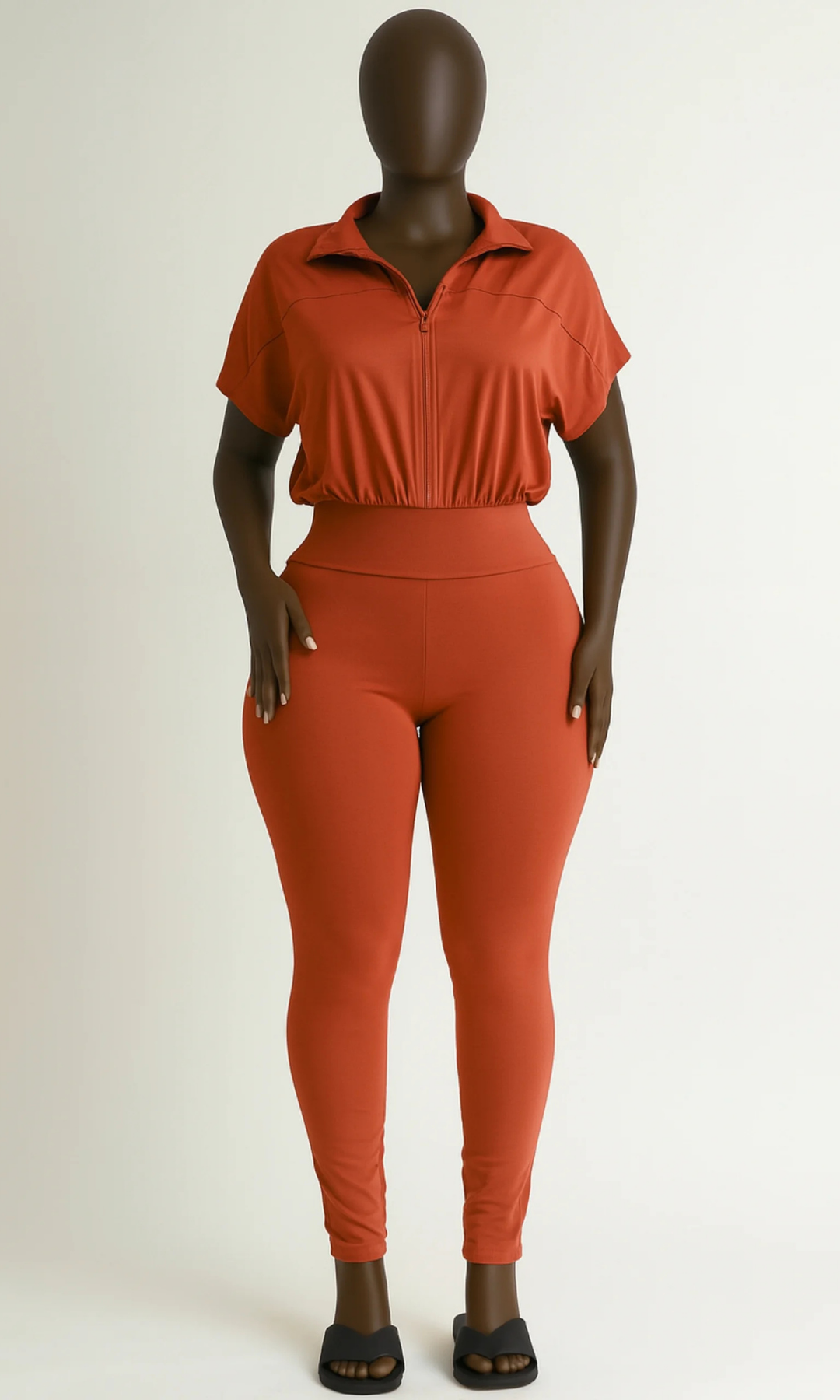 Front view of rust-colored short-sleeve jumpsuit on mannequin