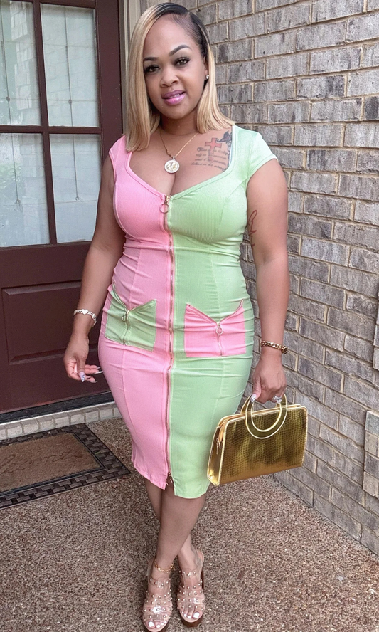 Front view of woman wearing pink and green two-tone dress with zipper detail