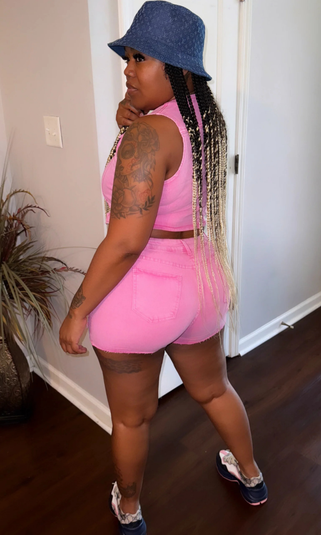 Back view of Poppin Pink 2-Piece Denim Set showcasing raw hem shorts and flattering fit.