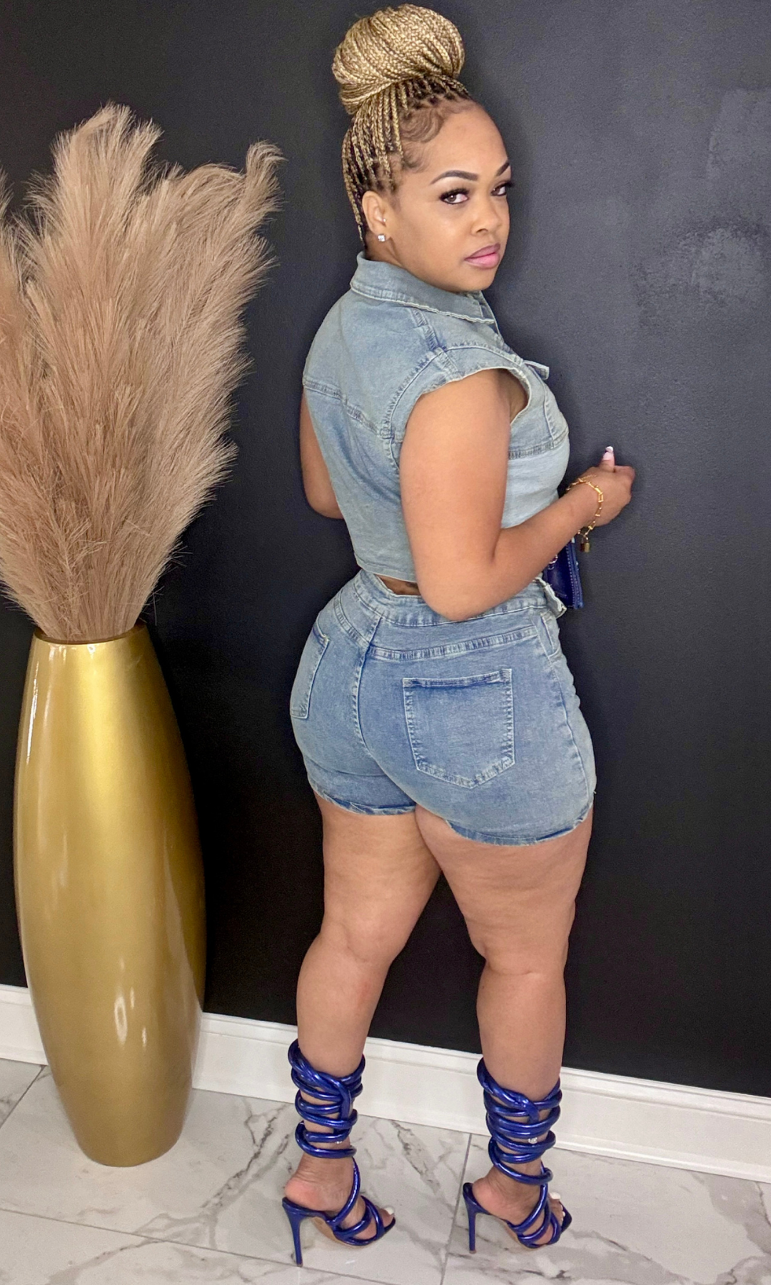 Side/back angle of Pretty Denim short set styled with blue strappy heels.