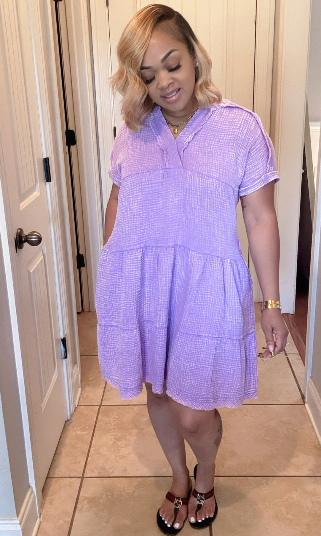 Front view of Purple Dress with split neckline, short sleeves, and tiered silhouette.